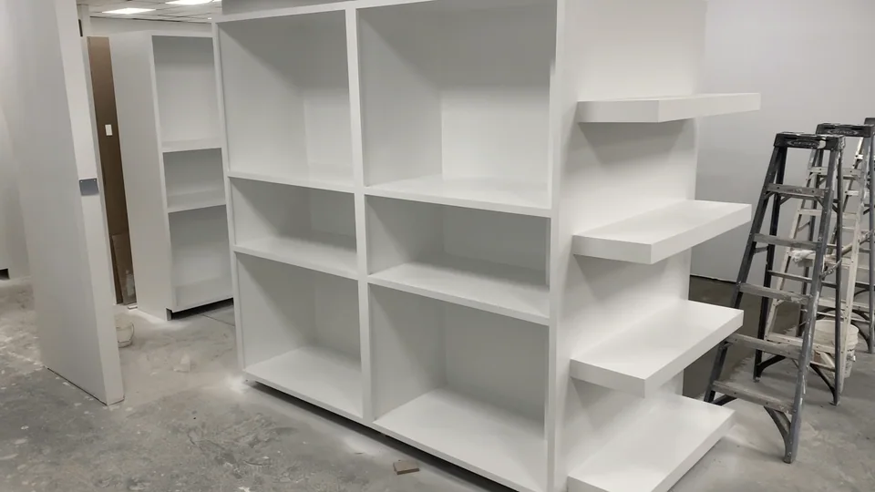 Custom finish carpentry shelving and trim detail during installation